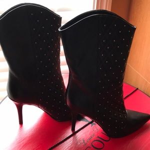 A pair of black leather studded Nine West boots.